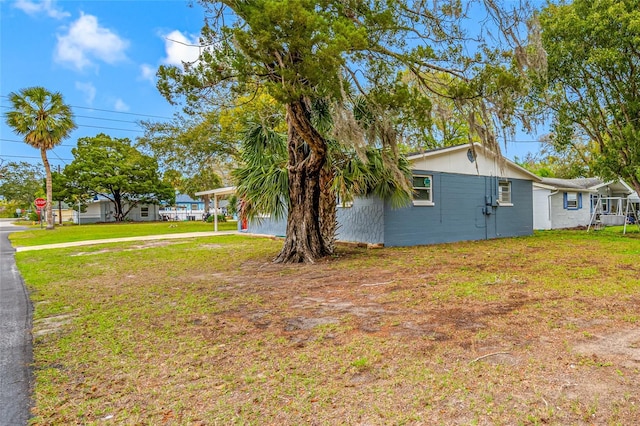 exterior space with a carport and a front yard