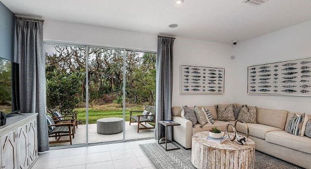 living room featuring light tile patterned floors, visible vents, and recessed lighting