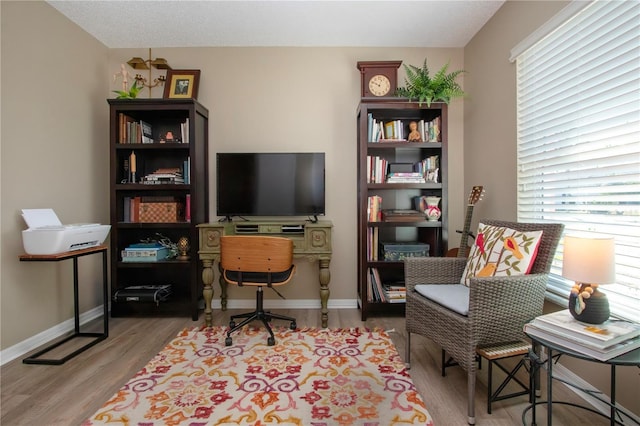 home office featuring baseboards and wood finished floors