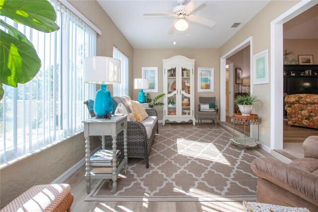 sunroom / solarium with a ceiling fan, visible vents, and a wealth of natural light