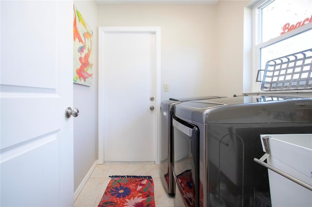 laundry room with light tile patterned floors, baseboards, laundry area, a sink, and washing machine and dryer