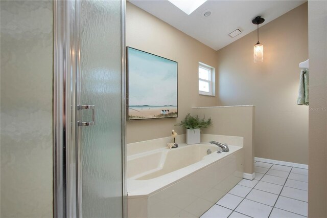 bathroom with visible vents, baseboards, lofted ceiling, a bath, and tile patterned floors