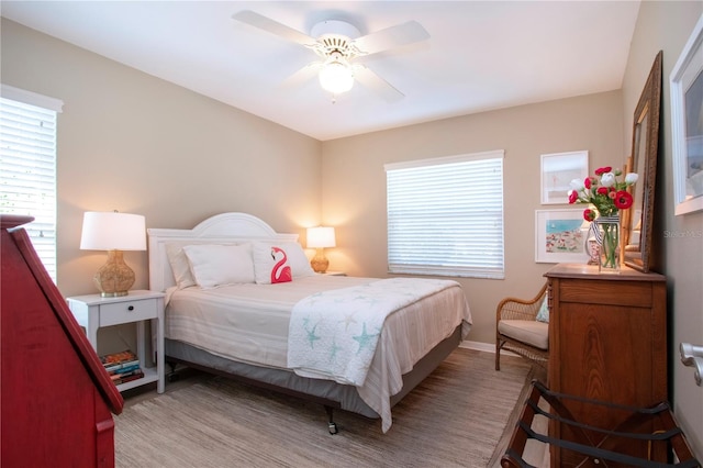 bedroom with a ceiling fan and baseboards