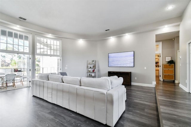 living area with recessed lighting, dark wood finished floors, visible vents, and baseboards