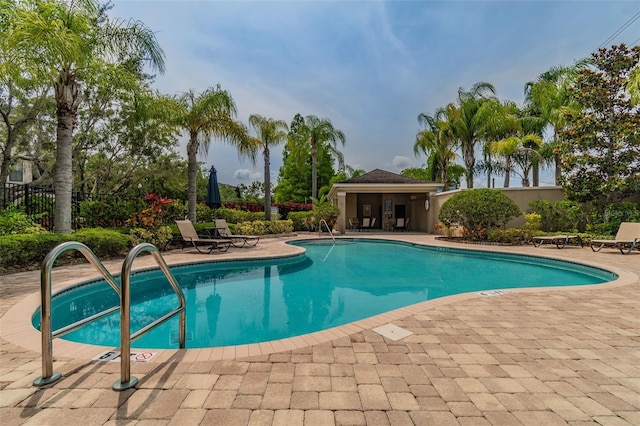 pool featuring a patio and fence