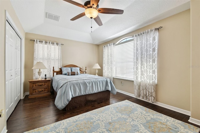 bedroom with visible vents, a raised ceiling, hardwood / wood-style flooring, and baseboards