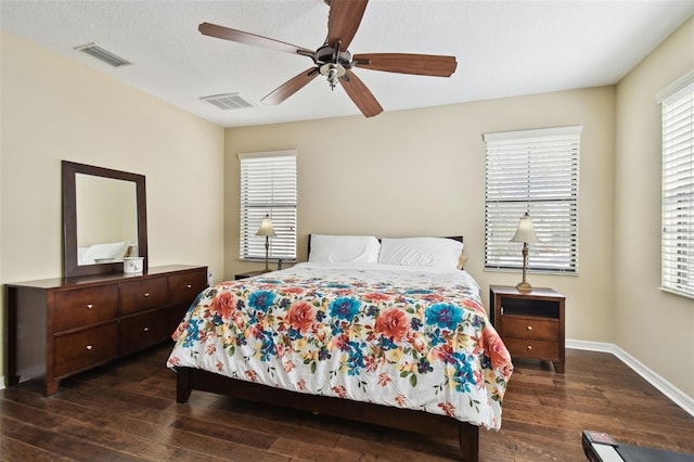 bedroom featuring multiple windows, visible vents, and wood finished floors