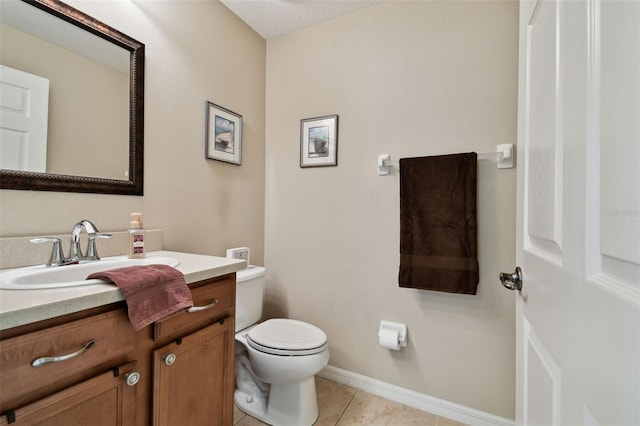 half bath featuring baseboards, vanity, toilet, and tile patterned floors