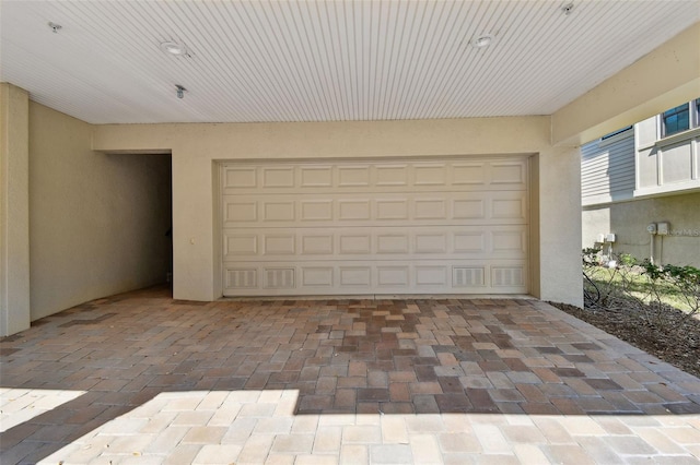 garage featuring decorative driveway