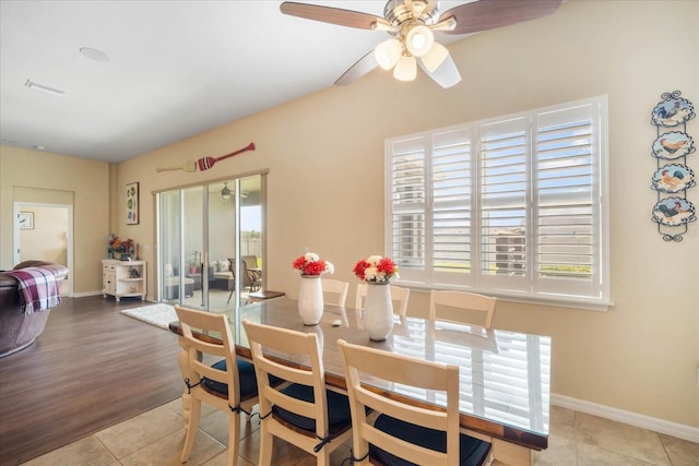 dining area featuring baseboards, a ceiling fan, and light tile patterned flooring