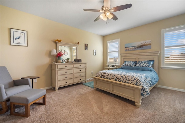 bedroom featuring baseboards, ceiling fan, and light colored carpet