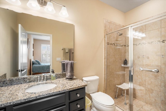 full bath featuring ensuite bathroom, vanity, a shower stall, and toilet