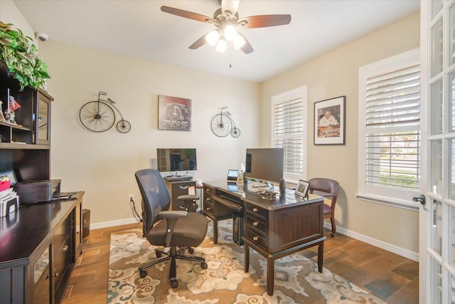 office area with ceiling fan, wood finished floors, and baseboards