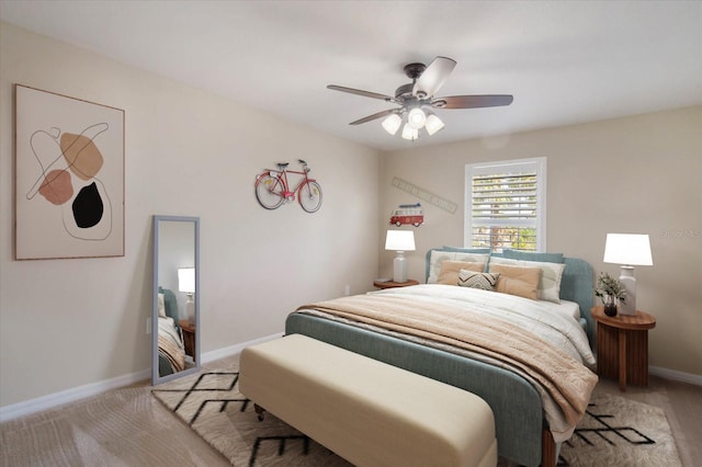 bedroom featuring light carpet, baseboards, and a ceiling fan