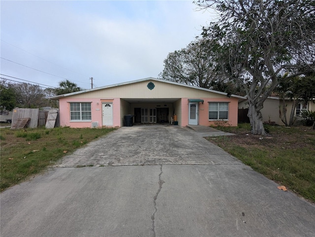 ranch-style house with a carport, a gate, and driveway