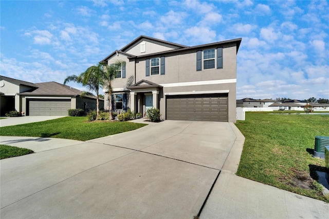 view of front facade featuring an attached garage, driveway, a front lawn, and stucco siding