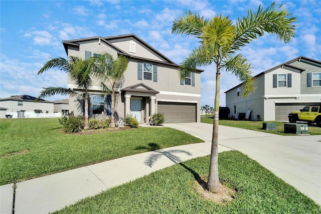 view of front facade featuring a garage, a front yard, concrete driveway, and stucco siding