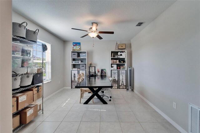 office with visible vents, a textured ceiling, baseboards, and light tile patterned floors