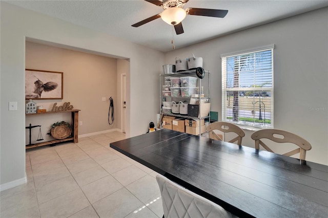 office area featuring a ceiling fan, a textured ceiling, baseboards, and tile patterned floors