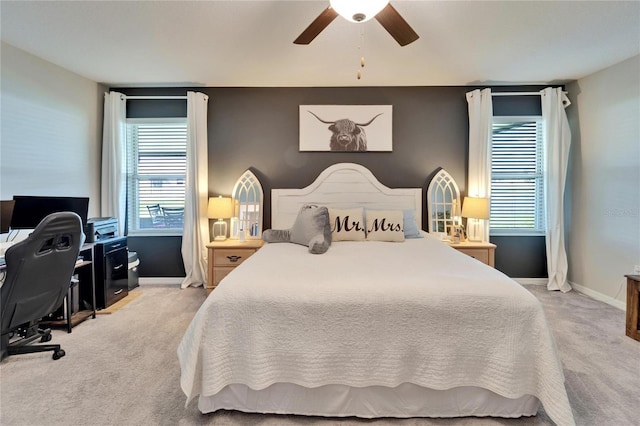 bedroom with light carpet, a ceiling fan, and baseboards