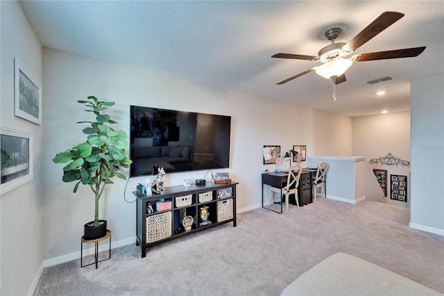 living area featuring carpet floors, visible vents, ceiling fan, and baseboards