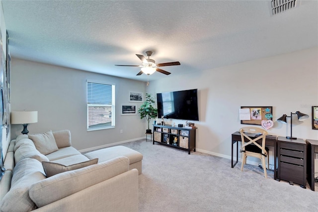 carpeted living area featuring a ceiling fan, baseboards, visible vents, and a textured ceiling