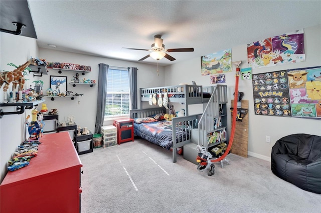 bedroom featuring a ceiling fan, carpet, a textured ceiling, and baseboards