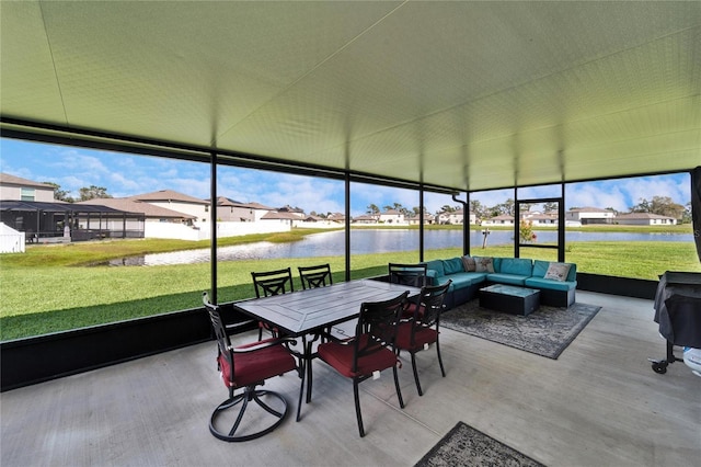 sunroom / solarium featuring a water view