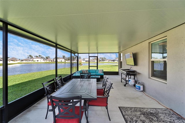 sunroom / solarium featuring a water view