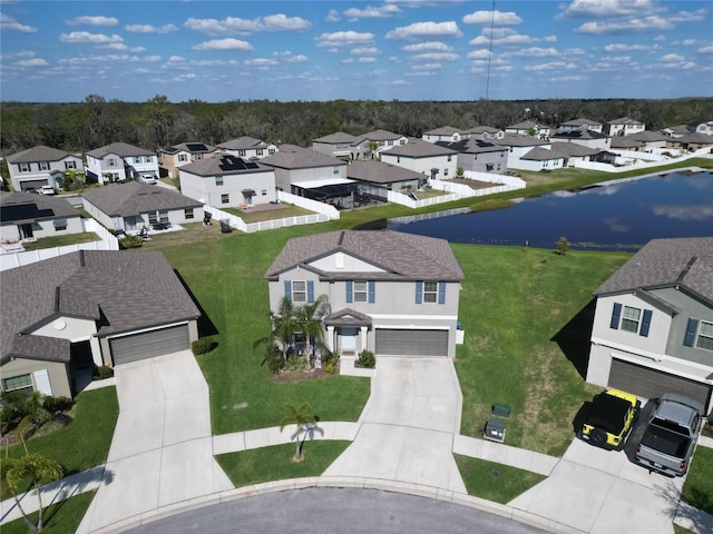 bird's eye view featuring a water view and a residential view