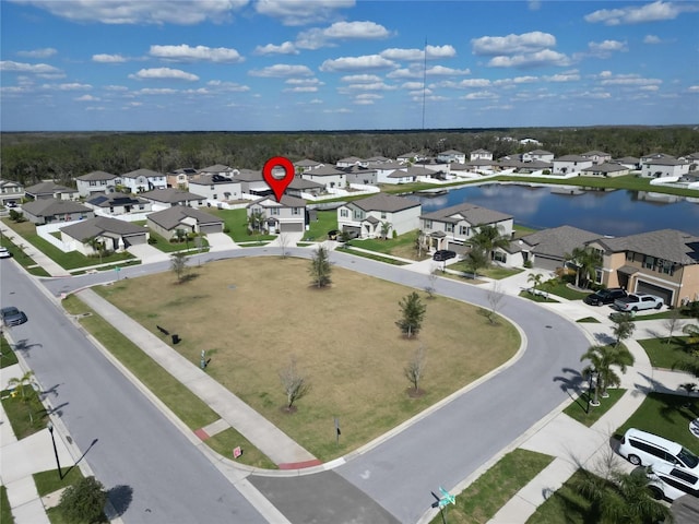 drone / aerial view with a water view and a residential view