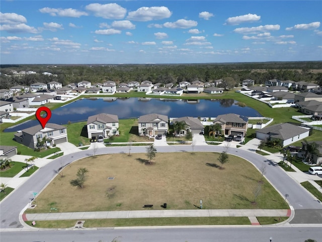 birds eye view of property with a water view and a residential view