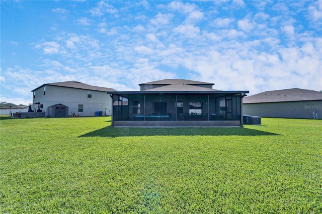 back of house featuring a lawn and a sunroom