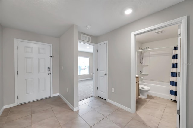 interior space with light tile patterned floors, baseboards, and visible vents