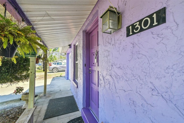 view of exterior entry featuring stucco siding