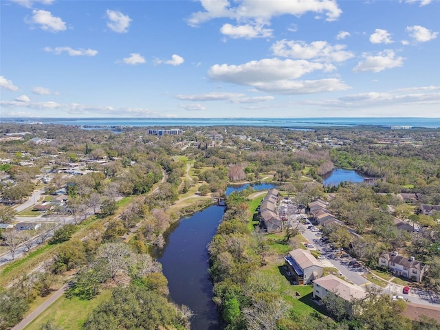 aerial view with a water view and a forest view