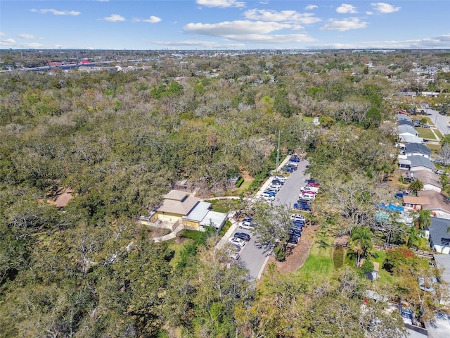 birds eye view of property with a view of trees