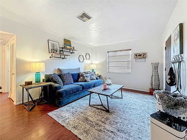 living room featuring wood finished floors and visible vents