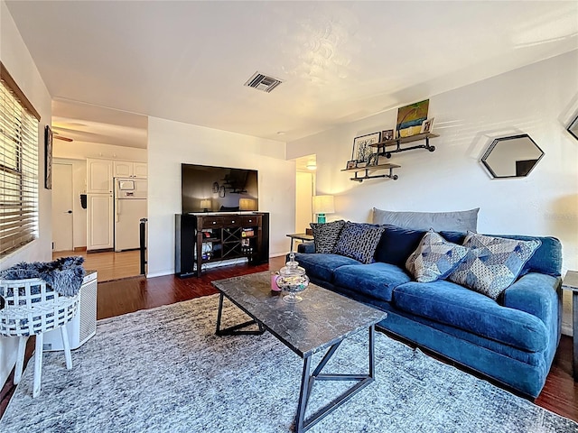 living room with wood finished floors and visible vents