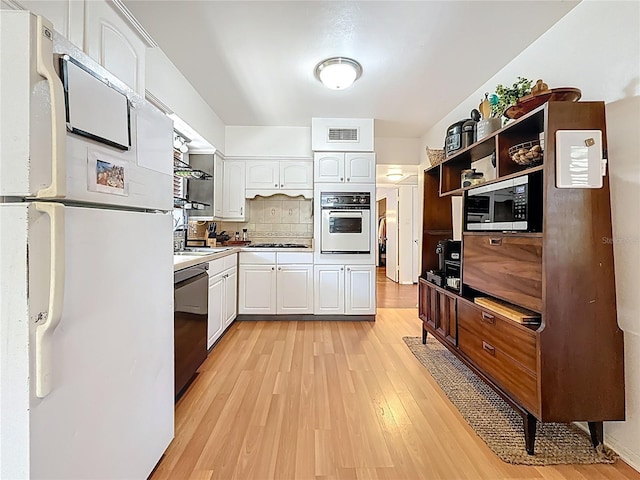 kitchen featuring open shelves, stainless steel appliances, visible vents, light wood-style floors, and white cabinetry