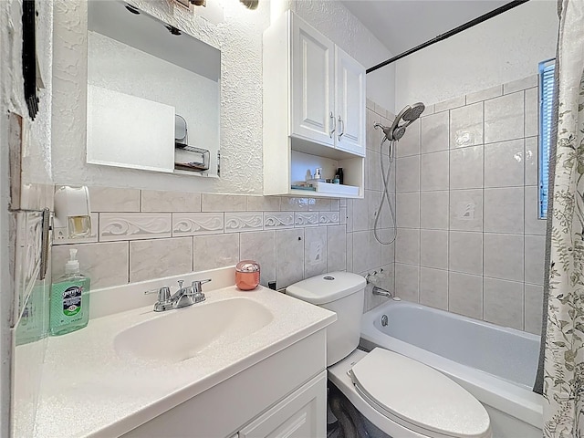 bathroom featuring toilet, vanity, tile walls, backsplash, and shower / bath combo with shower curtain