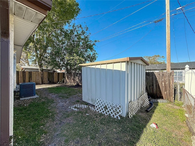 view of shed with a fenced backyard and central AC