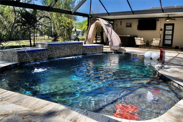 outdoor pool featuring a patio, ceiling fan, an in ground hot tub, a lanai, and a water slide