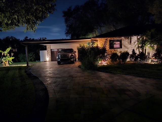 view of front of home with a carport and decorative driveway