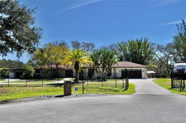 view of front facade featuring a garage, fence, concrete driveway, and a front yard