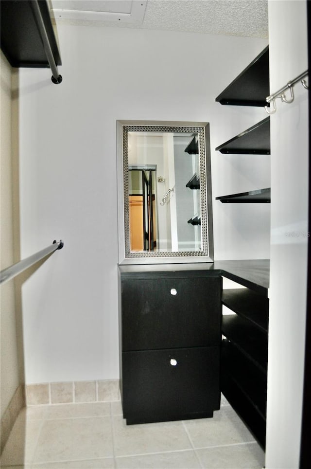 walk in closet featuring light tile patterned floors