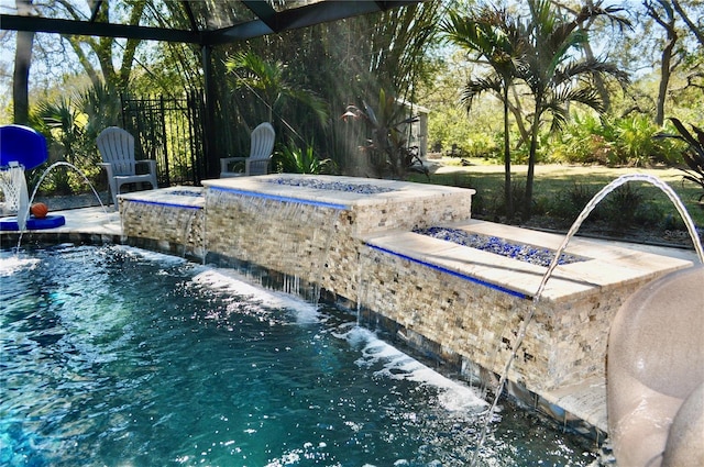 pool with an outdoor fire pit and a patio