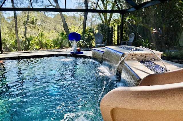 outdoor pool with glass enclosure and a patio area