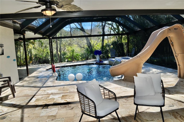 outdoor pool featuring a patio area, a lanai, a ceiling fan, and a jacuzzi