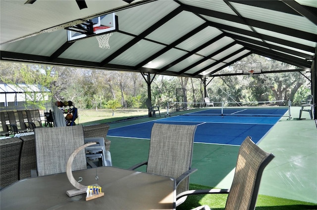 view of sport court featuring outdoor dining space